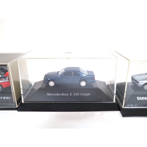 106 - Collection of 1:64 Scale cased model cars including Subaru Impreza WRC, Lancer Evolution WRC, BMW's ... 