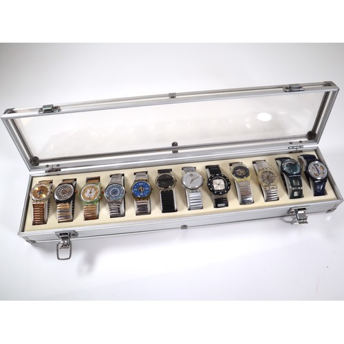 173 - 12 x Swatch Watches in Aluminium Display Case