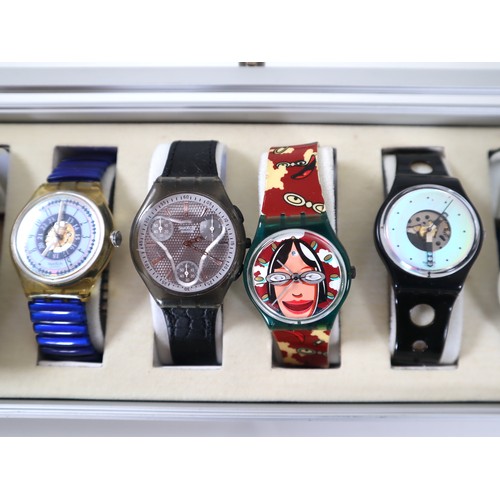 174 - 12 x Collectable Swatch Watches in Aluminium Display Case