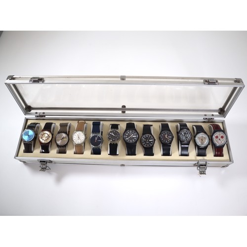 175 - 12 x Swatch Watches in Aluminium Display Case