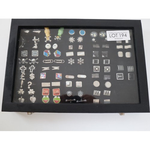 194 - Collection of various cufflinks in display case