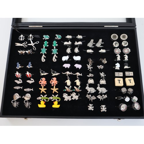 198 - Collection of novelty cufflinks animals / games in display case