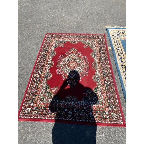 786 - A handmade blue Kayam Rug and a red rug