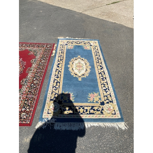 786 - A handmade blue Kayam Rug and a red rug