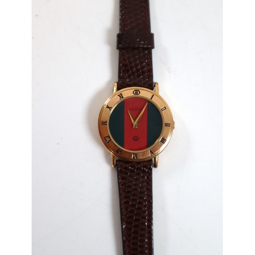 24 - Collection of watches including copies of Rolex, Breitling, Tag Heuer + Gold plated Gucci Watch