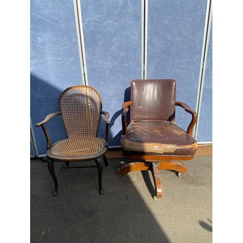 658 - A vintage leather swivel office chair and rattan seat/back arm chair.