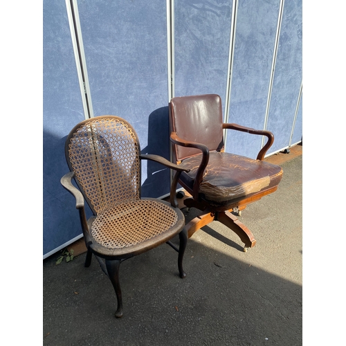 658 - A vintage leather swivel office chair and rattan seat/back arm chair.