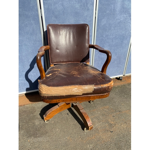 658 - A vintage leather swivel office chair and rattan seat/back arm chair.