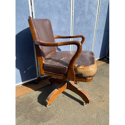 658 - A vintage leather swivel office chair and rattan seat/back arm chair.