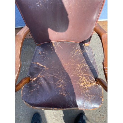 658 - A vintage leather swivel office chair and rattan seat/back arm chair.