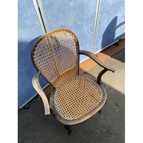 658 - A vintage leather swivel office chair and rattan seat/back arm chair.