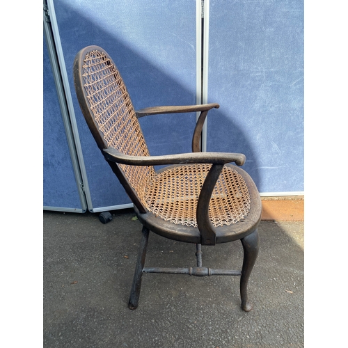 658 - A vintage leather swivel office chair and rattan seat/back arm chair.