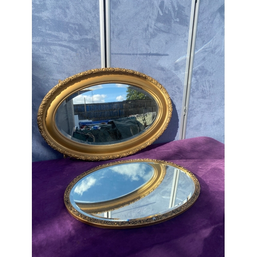 685 - Two oval gilt framed mirrors.