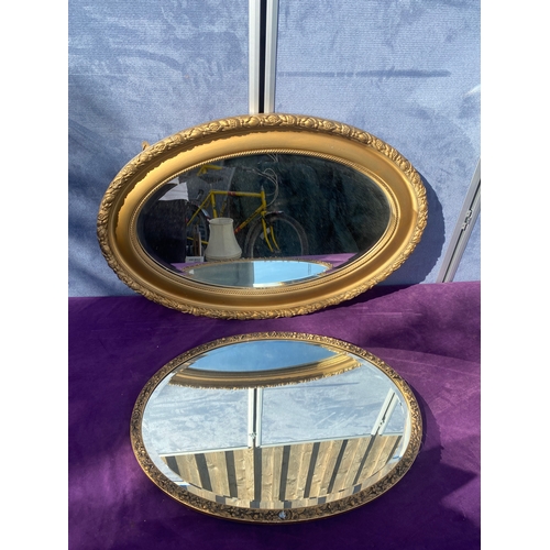 685 - Two oval gilt framed mirrors.