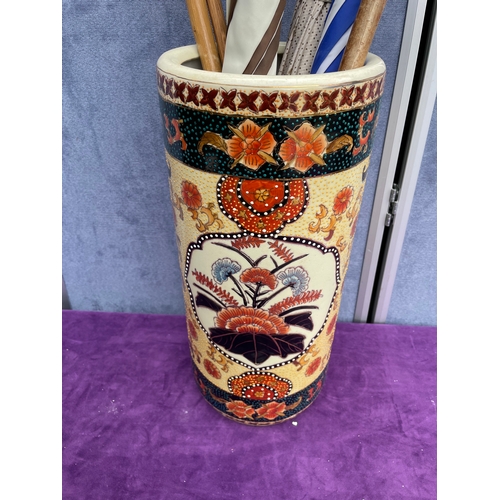 210 - Decorative Ceramic Umbrella/stick stand with wooden walking sticks and Umbrellas.