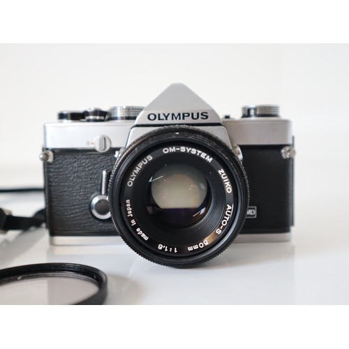 46 - Olympus 35mm Cameras - OM-1 w/ 50mm 1:1,8 Lens & OM-1n w/ 50mm 1:1 1,8 lens