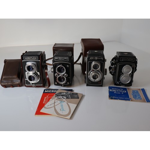 79 - Four Vintage TLR Cameras - Delmonta, Beautyflex, MPP Microcord, Hobiflex some with booklets and leat... 