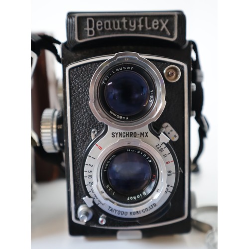 79 - Four Vintage TLR Cameras - Delmonta, Beautyflex, MPP Microcord, Hobiflex some with booklets and leat... 