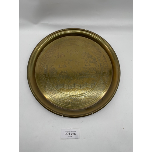 256 - Ornate small brass decorative plate.