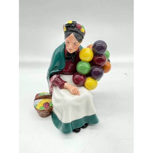290 - Three ceramic ornaments including Royal Doulton 'The old Balloon seller', 'The Puppet maker'