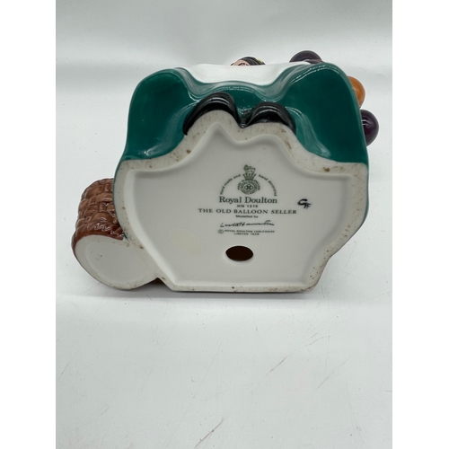 290 - Three ceramic ornaments including Royal Doulton 'The old Balloon seller', 'The Puppet maker'