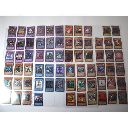 A group of 8 pages of Yu-Gi-Oh Trading Cards including singles from collectors tins , starter decks Rainbow Dragon, 1st editions, Elemental Heroes from 2005-2007 - all cards are in excellent to near mint condition approximately 100 cards