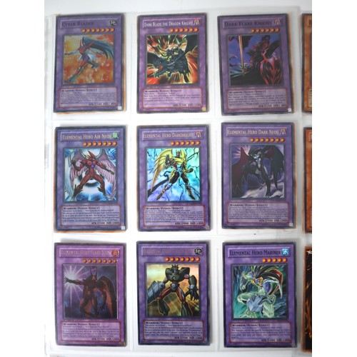 154 - A group of 8 pages of Yu-Gi-Oh Trading Cards including singles from collectors tins , starter decks ... 