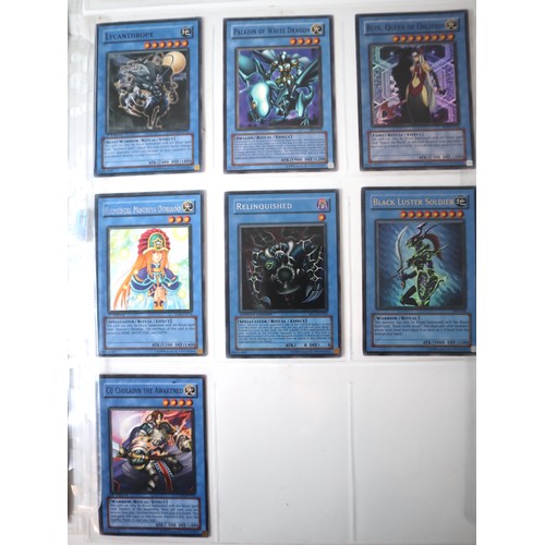 154 - A group of 8 pages of Yu-Gi-Oh Trading Cards including singles from collectors tins , starter decks ... 