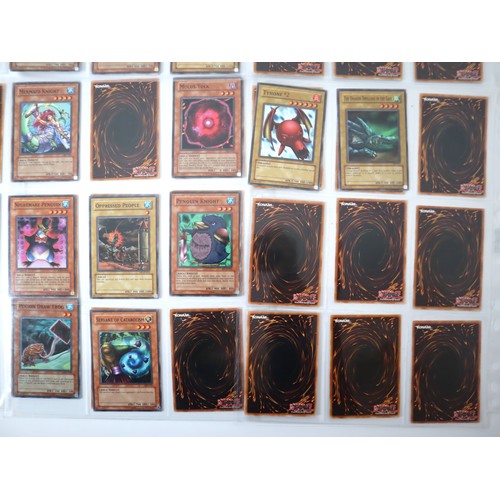 154 - A group of 8 pages of Yu-Gi-Oh Trading Cards including singles from collectors tins , starter decks ... 