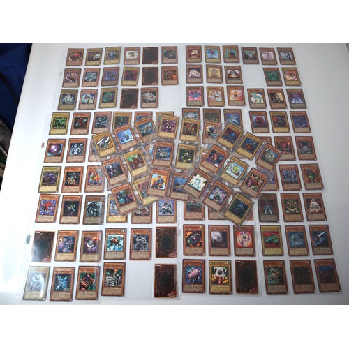 155 - A group of approximately 200 Yu-Gi-Oh Trading Cards including singles from collectors tins , starter... 