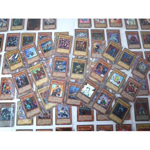 155 - A group of approximately 200 Yu-Gi-Oh Trading Cards including singles from collectors tins , starter... 