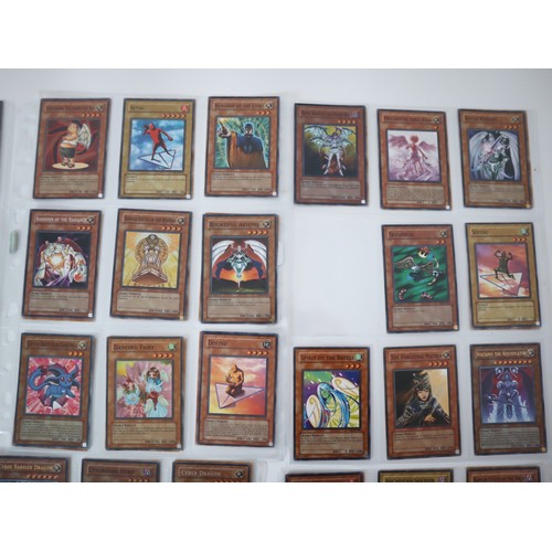 155 - A group of approximately 200 Yu-Gi-Oh Trading Cards including singles from collectors tins , starter... 