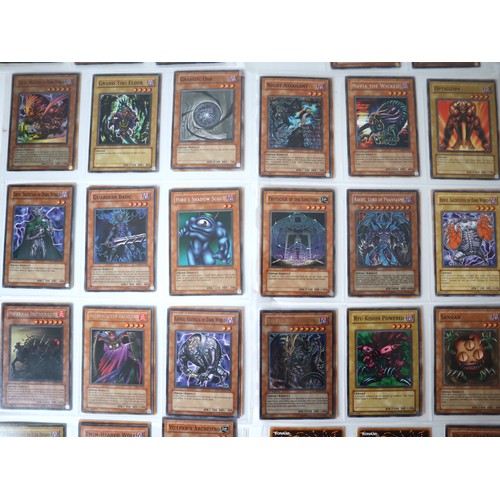 155 - A group of approximately 200 Yu-Gi-Oh Trading Cards including singles from collectors tins , starter... 