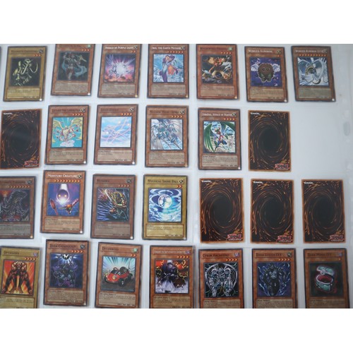 155 - A group of approximately 200 Yu-Gi-Oh Trading Cards including singles from collectors tins , starter... 