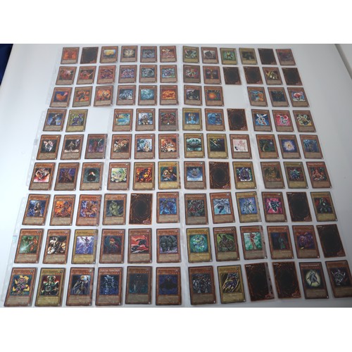 156 - A group of approximately 200 Yu-Gi-Oh Trading Cards including singles from collectors tins , starter... 