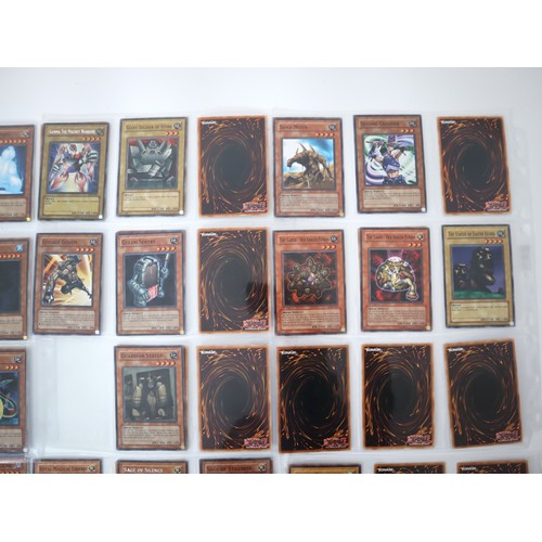 156 - A group of approximately 200 Yu-Gi-Oh Trading Cards including singles from collectors tins , starter... 