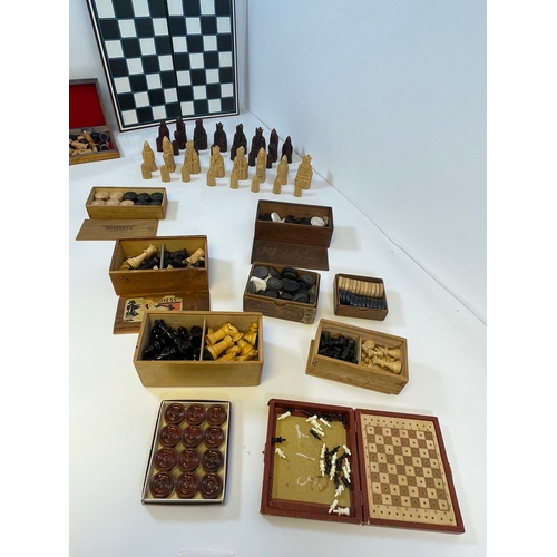 303 - A collection of Chess and Draughts pieces