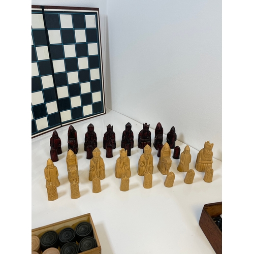 303 - A collection of Chess and Draughts pieces