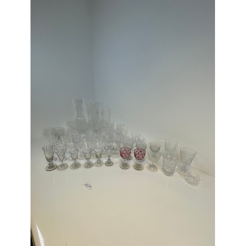 311 - A large collection of crystal glasses, decanter and a vase.