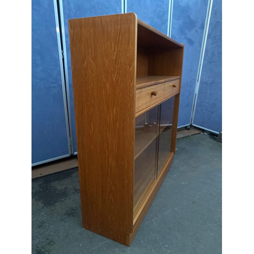 536 - Mid century Nathan glass front low book shelf with two drawers