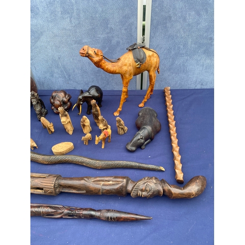 408 - A collection of wooden figures/ornaments and carved sticks.