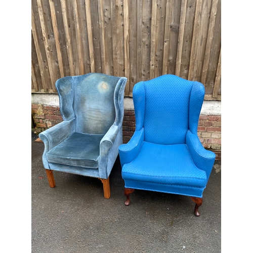 620 - Two upholstered wing back arm chairs.