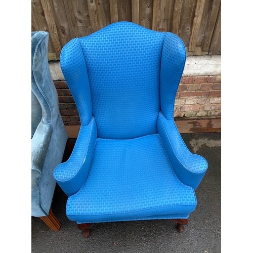 620 - Two upholstered wing back arm chairs.