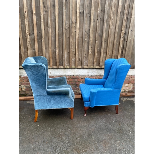 620 - Two upholstered wing back arm chairs.