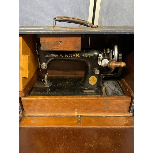 597 - Two Vintage Singer sewing machines and attachments