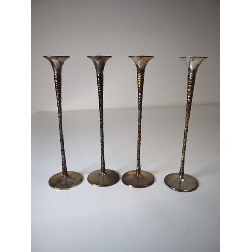 147 - A matched set of four Solid Silver candlestick holders by Stuart Devlin, the tapering parcel gilt st... 