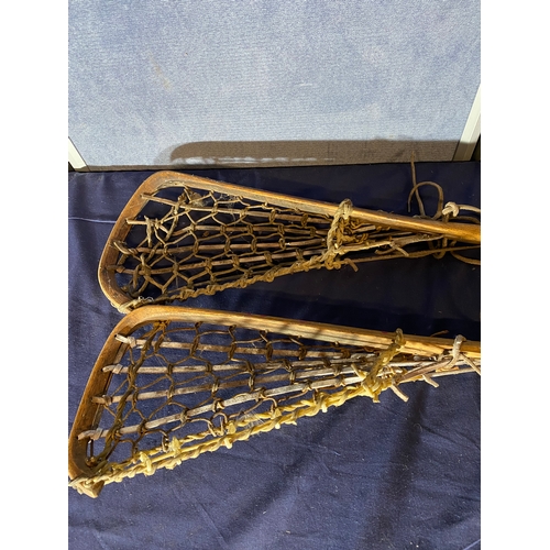 668 - A pair of Vintage wooden lacrosse sticks