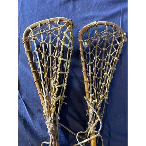 668 - A pair of Vintage wooden lacrosse sticks