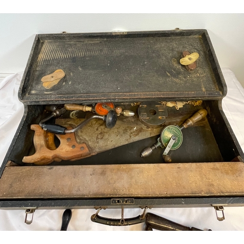 651 - Wooden tool box with hand drills and saws.