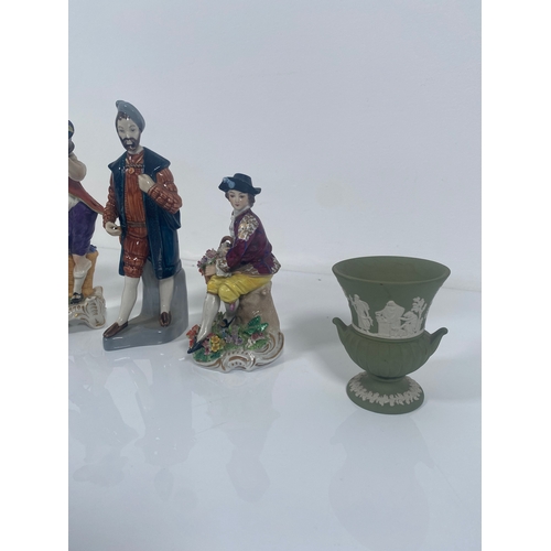 711 - Four ceramic collectable figurines and Two Wedgwood Vases